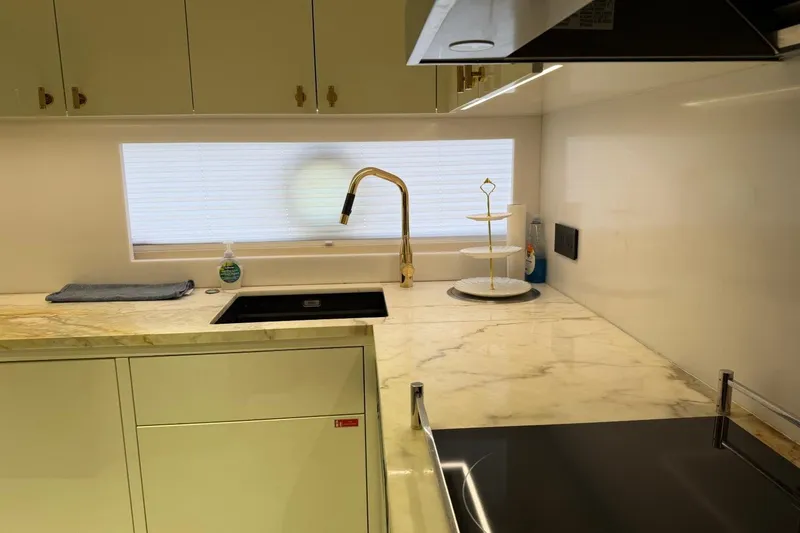 Slide: The Image of Modern kitchen in 2024 Sirena 88 yacht with marble countertops and sleek fixtures. - 155