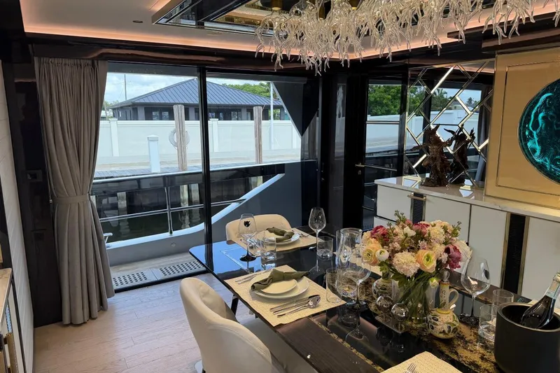 Slide: The Image of Luxurious dining area on 2024 Sirena 88 yacht, featuring elegant decor and floral centerpiece. - 112