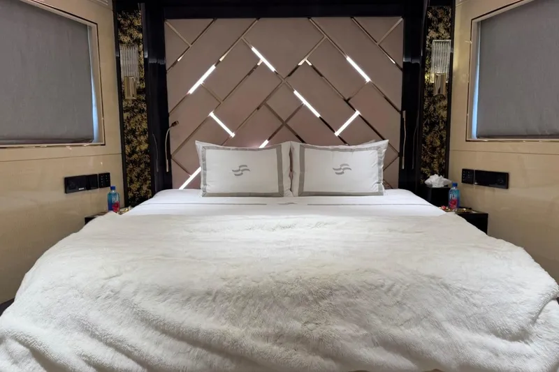 Slide: The Image of Luxurious bedroom interior of 2024 Sirena 88 yacht with plush bedding and elegant decor. - 85