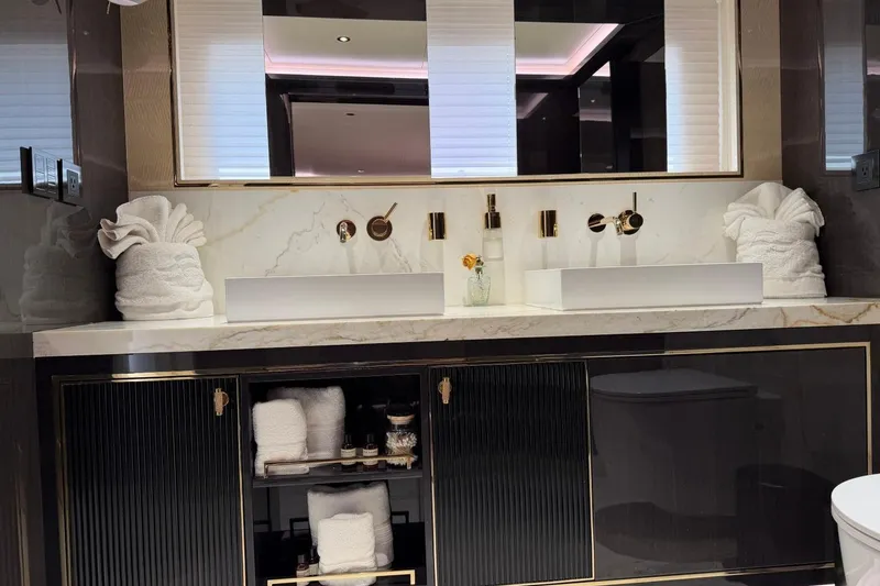 Slide: The Image of Luxurious bathroom vanity on Sirena 88 yacht, 2024 model, featuring elegant marble and gold accents. - 71