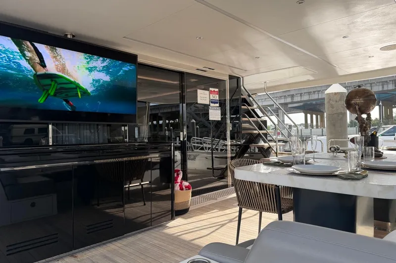 Slide: The Image of Luxurious 2024 Sirena 88 yacht interior with dining area and entertainment screen. - 22