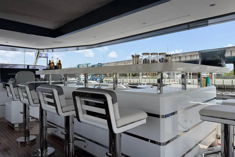Slide: The Image of Luxurious interior of 2024 Sirena 88 yacht featuring a sleek bar area with modern seating. - 43