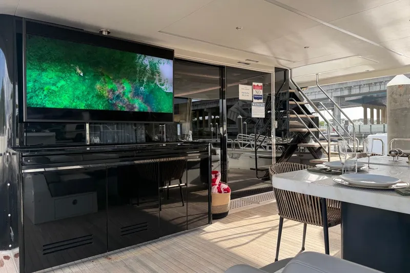 Slide: The Image of Luxurious 2024 Sirena 88 yacht interior with dining area and large TV screen. - 24