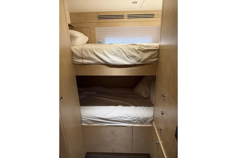 Slide: The Image of Bunk beds in 2024 Sirena 88 yacht cabin with wooden interior. - 139