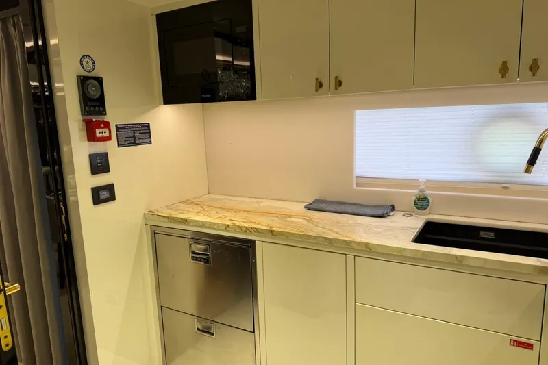 Slide: The Image of Modern kitchen interior of 2024 Sirena 88 yacht with sleek cabinetry and appliances. - 156