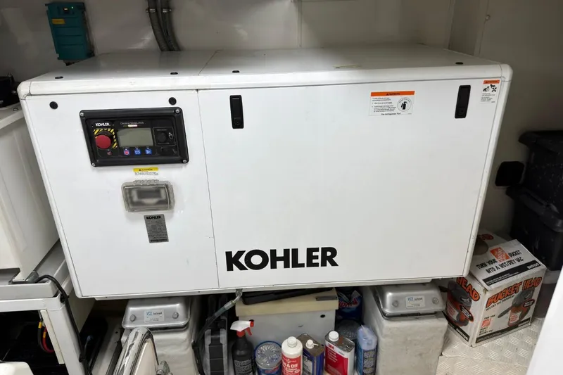 Slide: The Image of Kohler generator in a 2024 Sirena 88 yacht engine room, surrounded by maintenance supplies. - 145