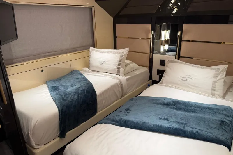 Slide: The Image of Luxurious twin cabin interior of 2024 Sirena 88 yacht, featuring elegant bedding and modern design. - 82