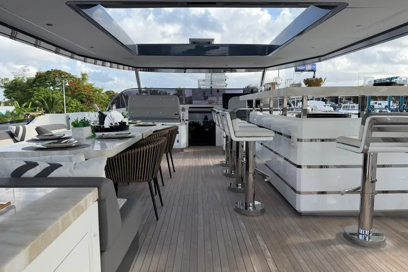 Slide: The Image of Luxurious 2024 Sirena 88 yacht interior with elegant dining and bar area. - 25