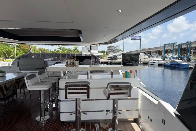 Slide: The Image of Luxurious 2024 Sirena 88 yacht interior with bar stools and marina view. - 52
