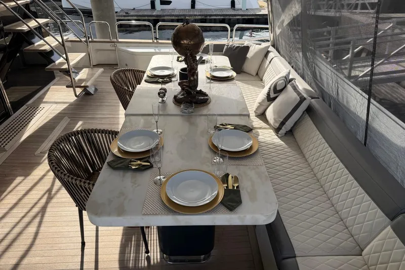 Slide: The Image of Luxurious dining setup on 2024 Sirena 88 yacht with elegant tableware and plush seating. - 19