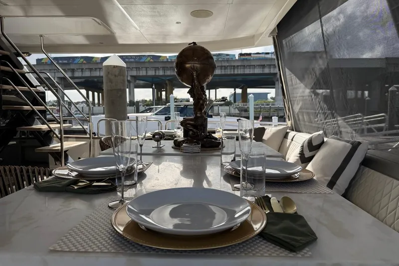 Slide: The Image of Elegant dining setup on 2024 Sirena 88 yacht, featuring modern tableware and luxurious seating. - 20