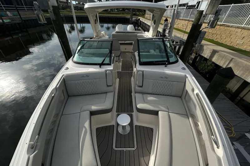 Slide: The Image of 2024 Sea Ray SLX 310 Outboard boat with luxurious seating and sleek design at a dock. - 102