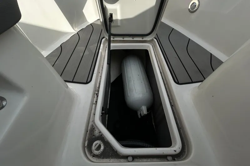 Slide: The Image of Storage compartment on 2024 Sea Ray SLX 310 Outboard boat, featuring a fender inside. - 106