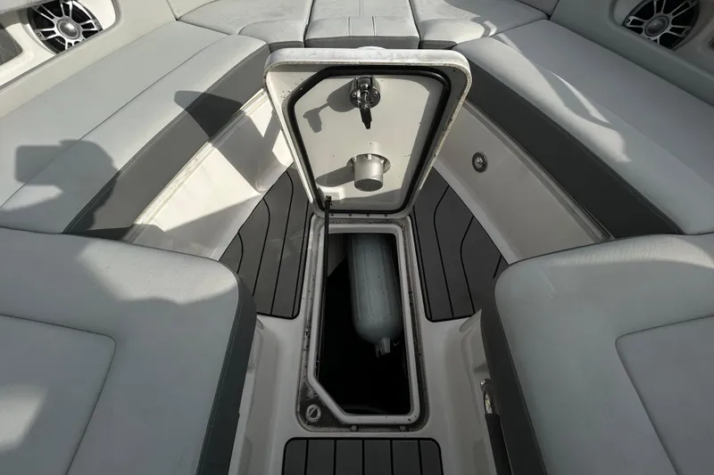 Slide: The Image of 2024 Sea Ray SLX 310 Outboard interior storage compartment with sleek seating and modern design. - 108