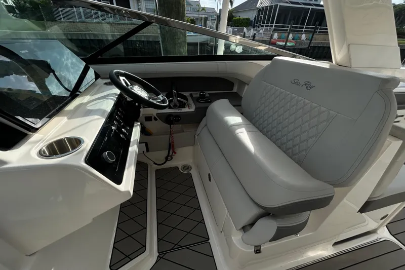 Slide: The Image of 2024 Sea Ray SLX 310 Outboard helm with luxurious seating and modern controls. - 113
