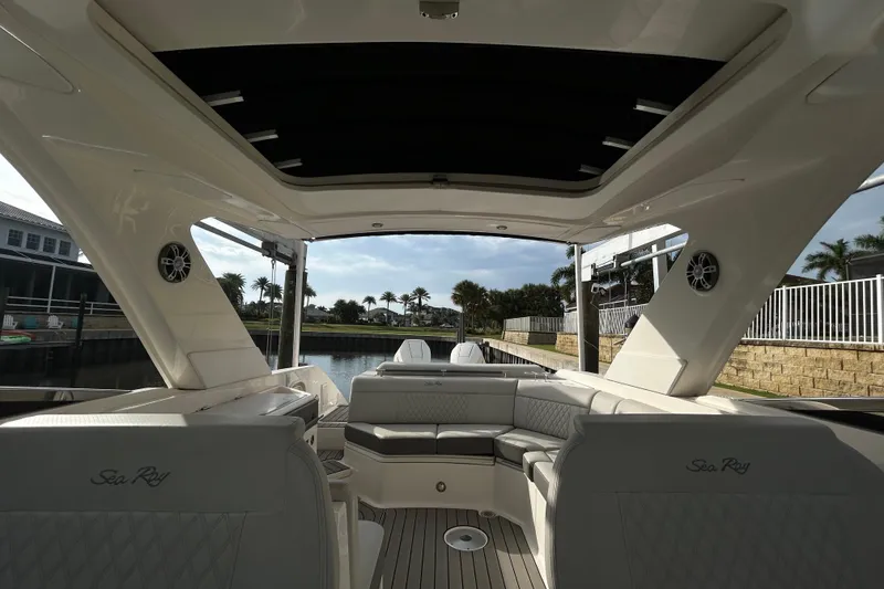 Slide: The Image of Interior view of 2024 Sea Ray SLX 310 Outboard, showcasing luxurious seating and sleek design. - 116