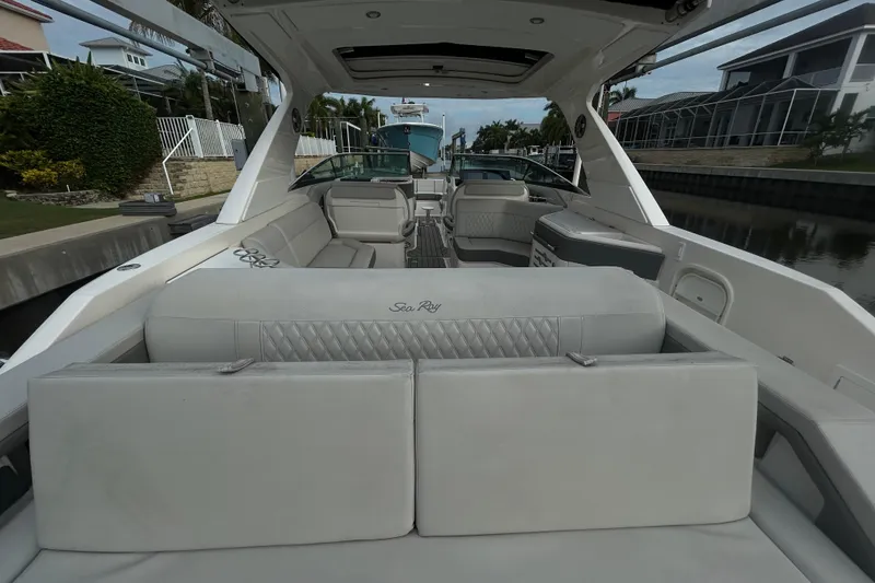 Slide: The Image of 2024 Sea Ray SLX 310 Outboard luxury boat interior with plush seating and modern design. - 12