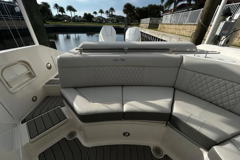 Slide: The Image of 2024 Sea Ray SLX 310 Outboard boat interior with elegant seating and waterfront view. - 123