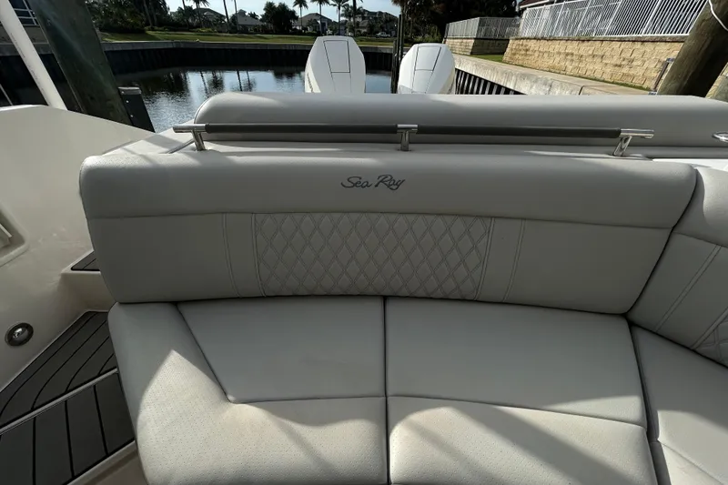 Slide: The Image of 2024 Sea Ray SLX 310 Outboard boat seating with elegant stitching and branding. - 125