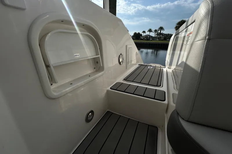 Slide: The Image of 2024 Sea Ray SLX 310 Outboard boat interior with sleek seating and storage compartment. - 128