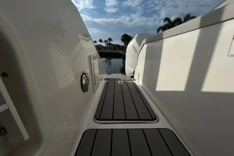 Slide: The Image of 2024 Sea Ray SLX 310 Outboard boat deck with scenic water view. - 129