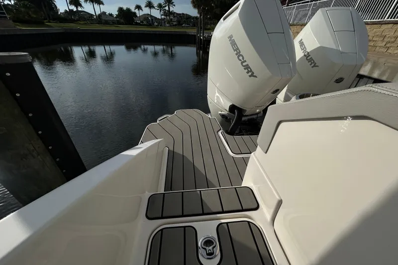 Slide: The Image of 2024 Sea Ray SLX 310 Outboard with Mercury engines, docked by a serene waterfront. - 130