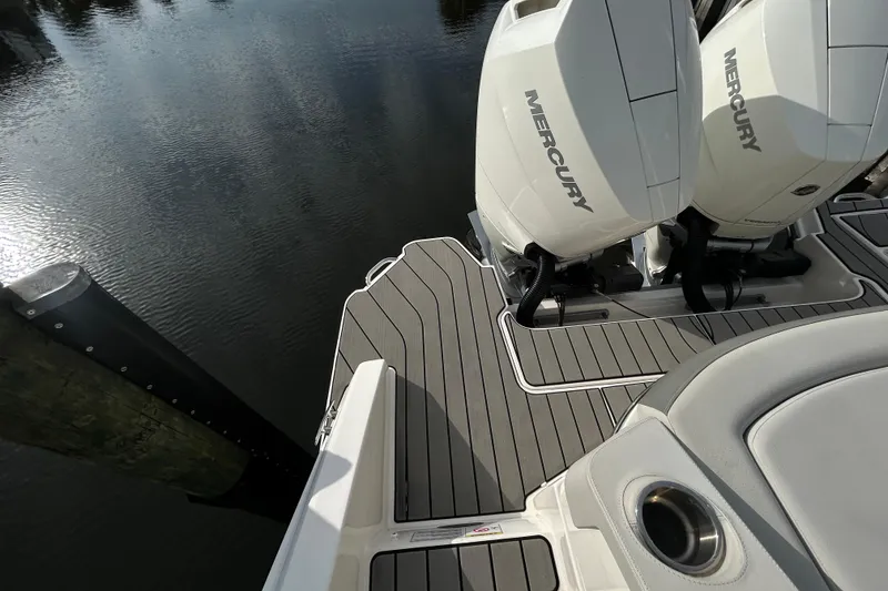 Slide: The Image of 2024 Sea Ray SLX 310 Outboard with dual Mercury engines on a sleek deck. - 131