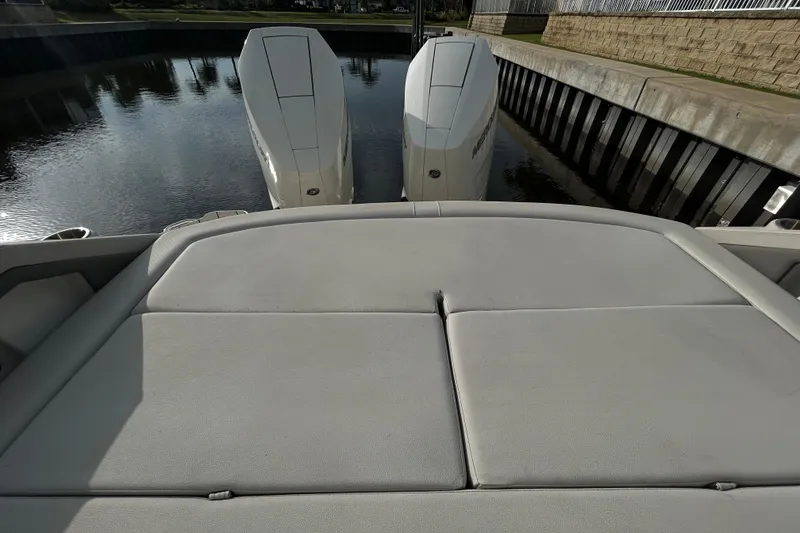 Slide: The Image of 2024 Sea Ray SLX 310 Outboard with dual engines, docked in calm waters. - 132
