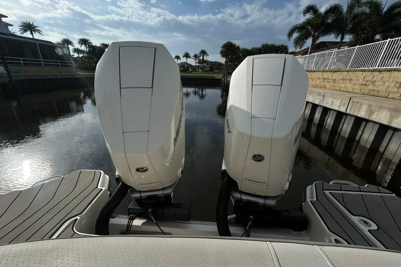 Slide: The Image of 2024 Sea Ray SLX 310 Outboard engines docked by a serene waterfront. - 134