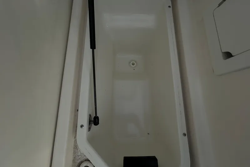 Slide: The Image of 2024 Sea Ray SLX 310 Outboard storage compartment interior view. - 19