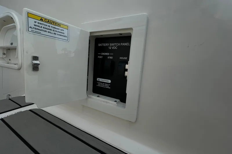Slide: The Image of Battery switch panel on 2024 Sea Ray SLX 310 Outboard boat, caution label visible. - 20