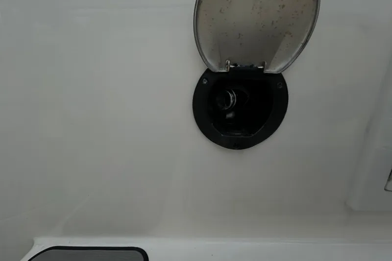 Slide: The Image of Fuel cap of 2024 Sea Ray SLX 310 Outboard boat, open for refueling. - 22