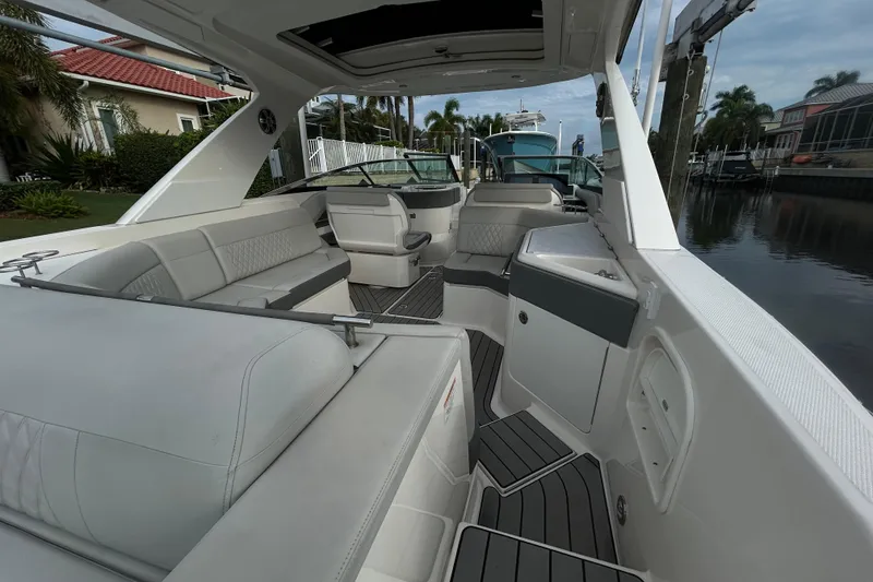 Slide: The Image of 2024 Sea Ray SLX 310 Outboard interior with luxurious seating and sleek design. - 24
