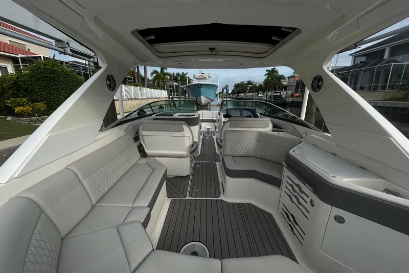 Slide: The Image of 2024 Sea Ray SLX 310 Outboard boat interior with luxurious seating and modern design. - 27