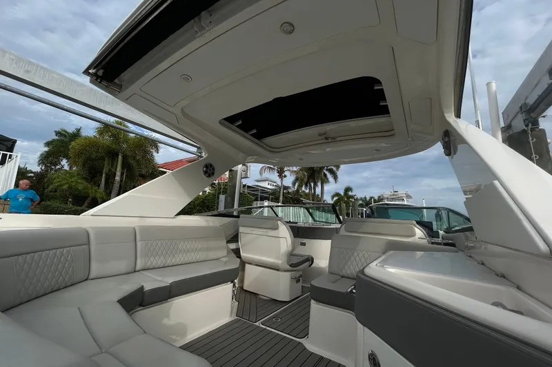Slide: The Image of 2024 Sea Ray SLX 310 Outboard interior with luxurious seating and open roof design. - 31