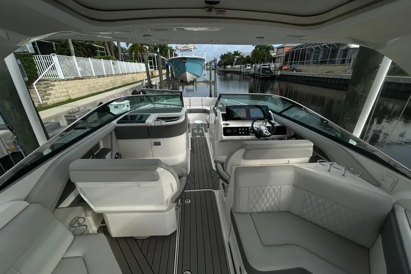 Slide: The Image of 2024 Sea Ray SLX 310 Outboard interior with luxurious seating and modern dashboard. - 35