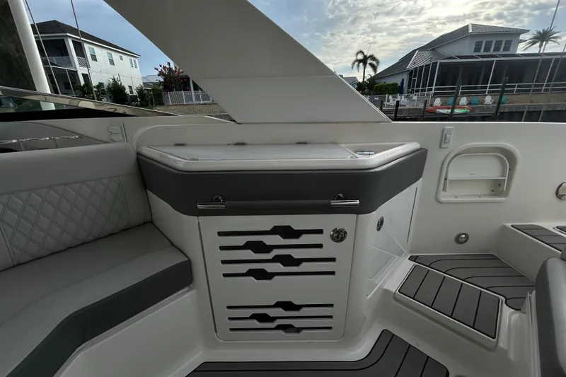 Slide: The Image of 2024 Sea Ray SLX 310 Outboard interior with sleek seating and modern design elements. - 36
