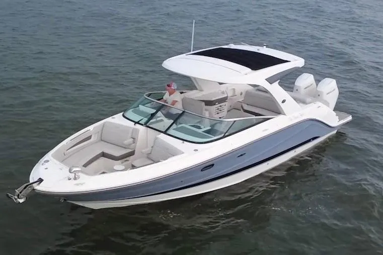 Slide: The Image of 2024 Sea Ray SLX 310 Outboard boat cruising on open water. - 2
