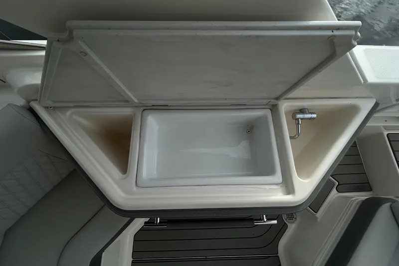 Slide: The Image of An open sink on a boat with gray upholstery. - 39