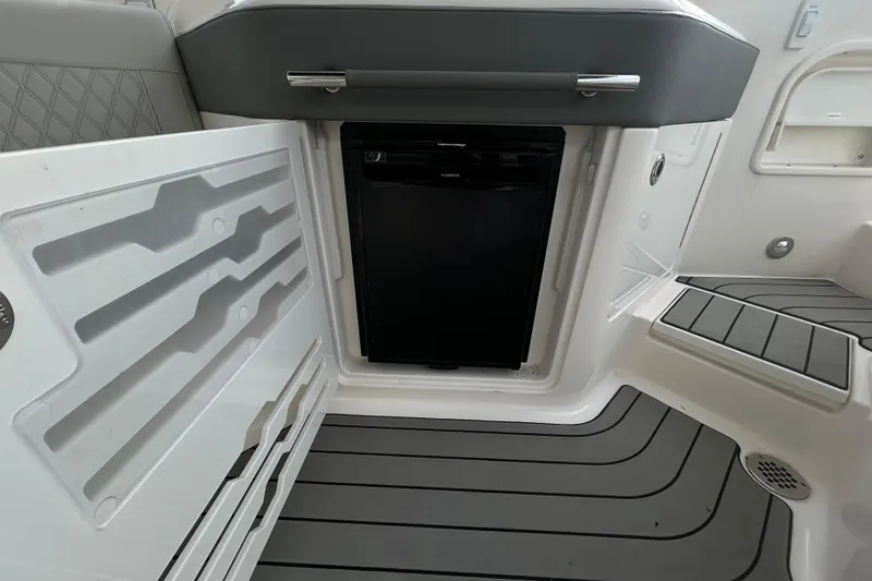 Slide: The Image of 2024 Sea Ray SLX 310 Outboard interior with built-in storage and seating. - 42