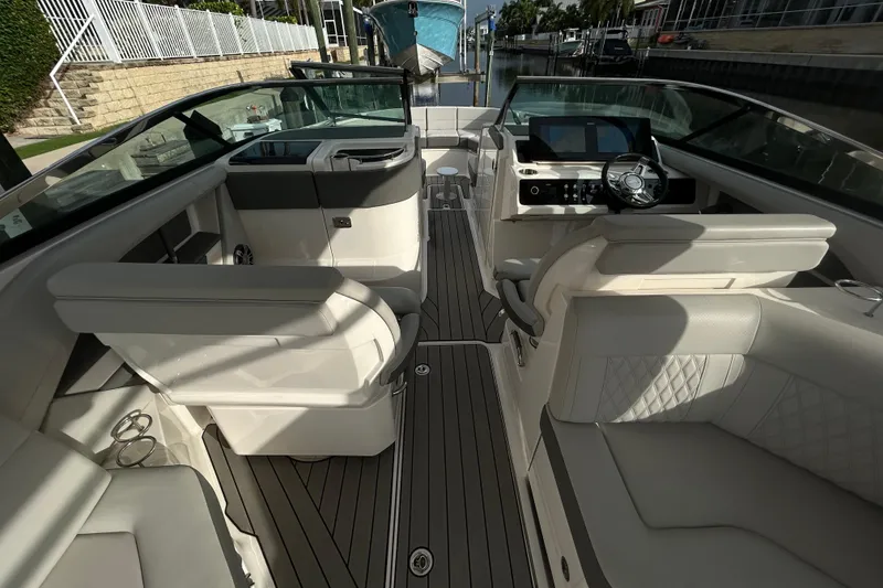 Slide: The Image of 2024 Sea Ray SLX 310 Outboard interior with luxurious seating and modern dashboard. - 50