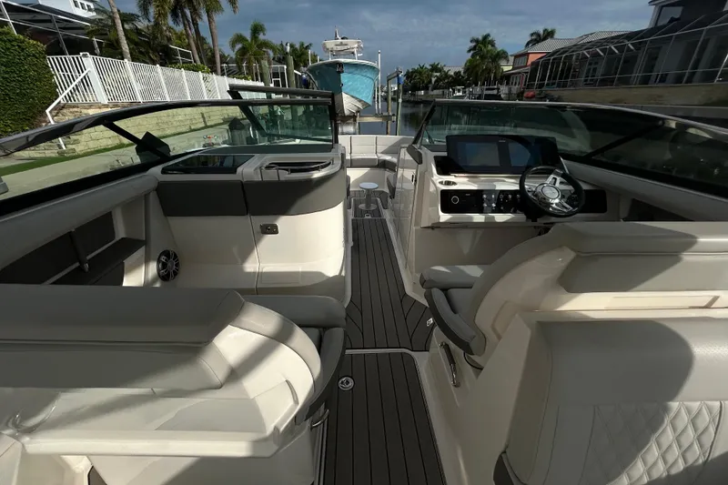 Slide: The Image of 2024 Sea Ray SLX 310 Outboard interior with luxurious seating and modern dashboard. - 51