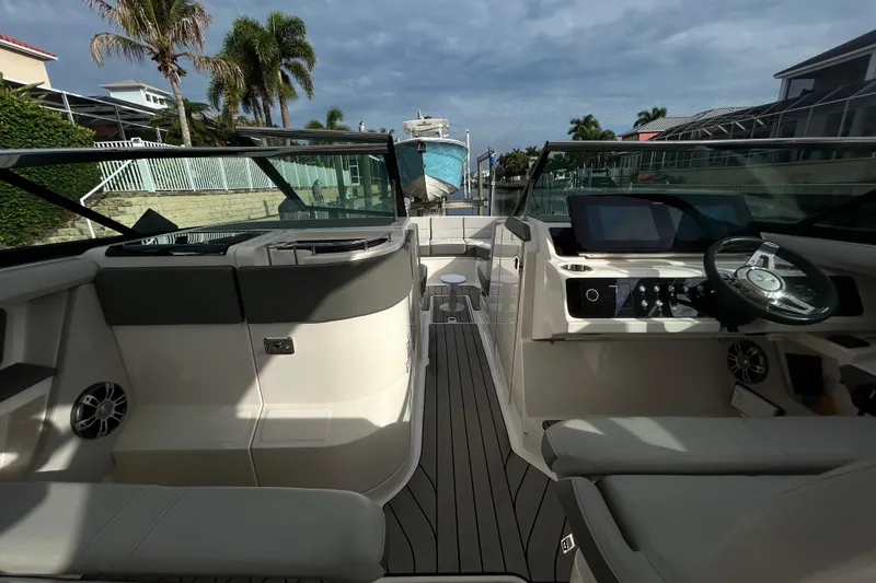 Slide: The Image of 2024 Sea Ray SLX 310 Outboard interior with modern helm and luxurious seating. - 52