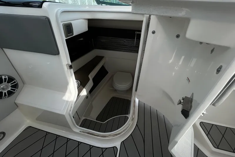 Slide: The Image of 2024 Sea Ray SLX 310 Outboard interior cabin with toilet and sleek design. - 56