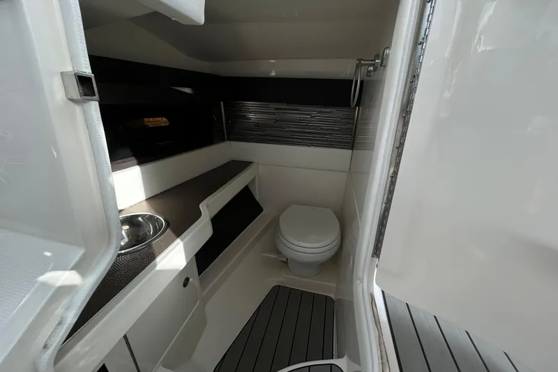 Slide: The Image of 2024 Sea Ray SLX 310 Outboard boat bathroom interior with modern fixtures. - 57