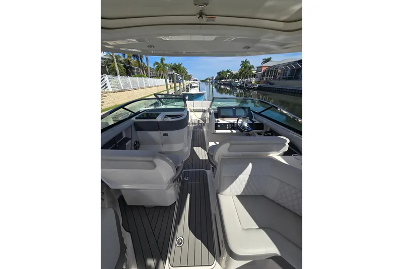 Slide: The Image of 2024 Sea Ray SLX 310 Outboard interior with luxurious seating and modern dashboard. - 6
