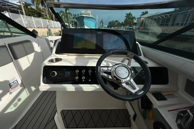 Slide: The Image of 2024 Sea Ray SLX 310 Outboard helm with modern controls and navigation display. - 66