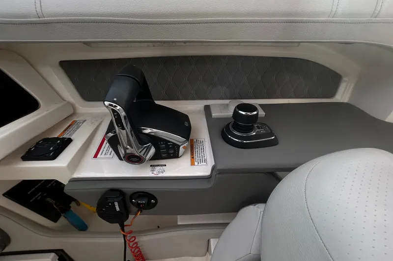 Slide: The Image of 2024 Sea Ray SLX 310 Outboard helm controls with joystick and throttle. - 68