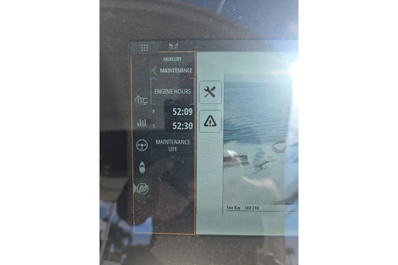 Slide: The Image of Display screen of 2024 Sea Ray SLX 310 Outboard showing engine hours and maintenance alerts. - 7