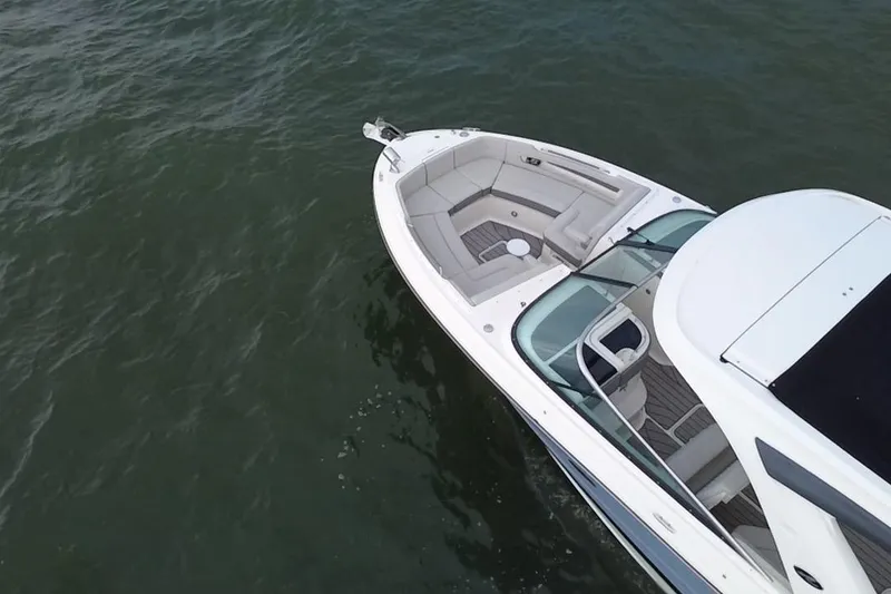 Slide: The Image of 2024 Sea Ray SLX 310 Outboard boat on calm water, aerial view. - 13